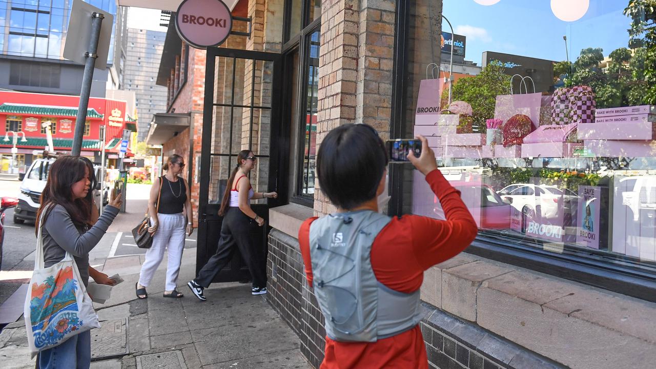 People looking at cookbooks and products at the Brooki bakehouse