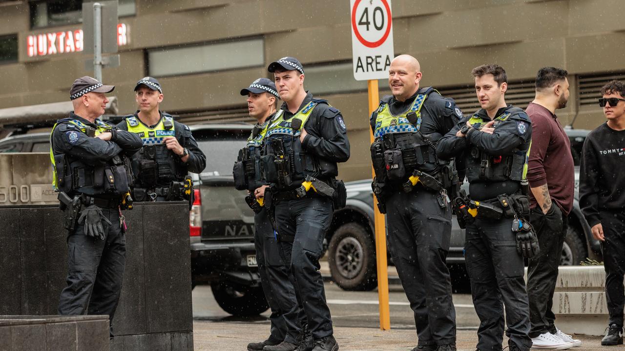Police watch on at a rally against the North West Shelf expansion.