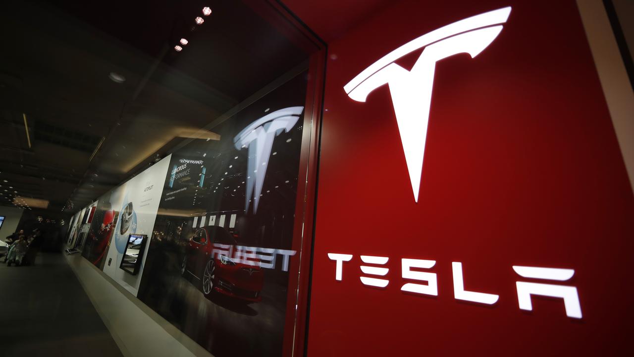 Tesla logo is seen at the company's store