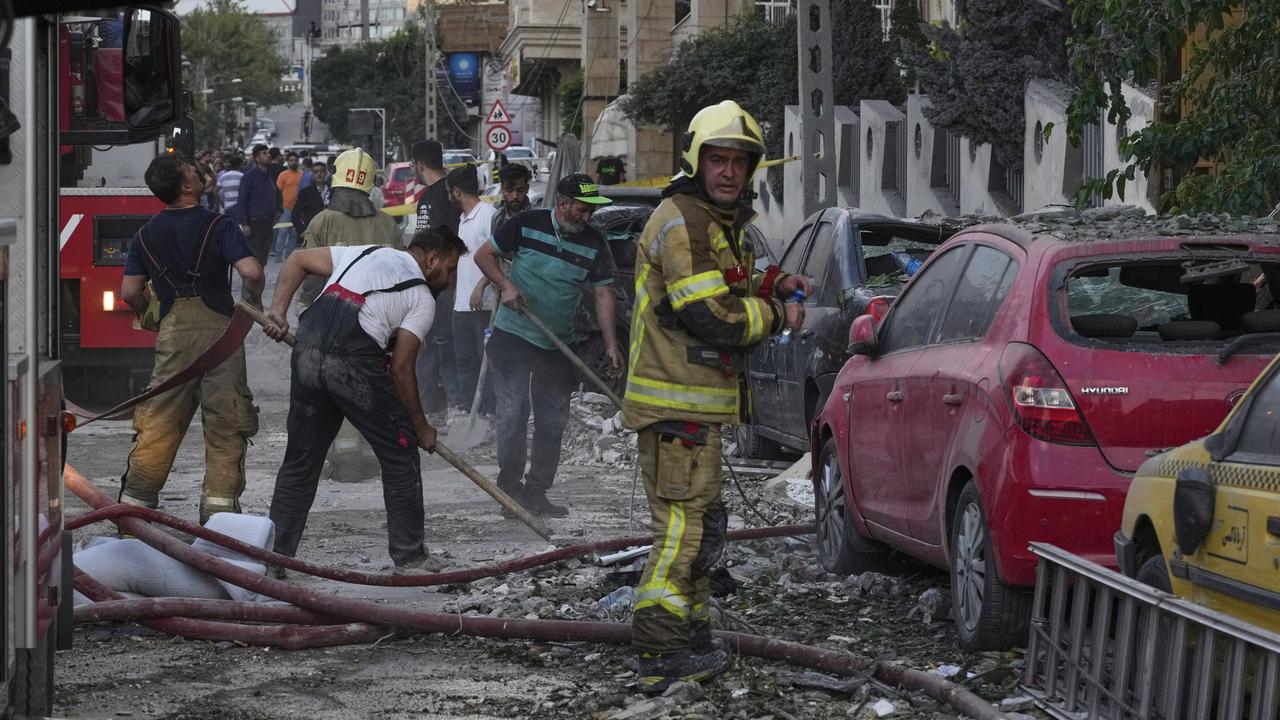 Firefighters and people clean up Israeli strikes
