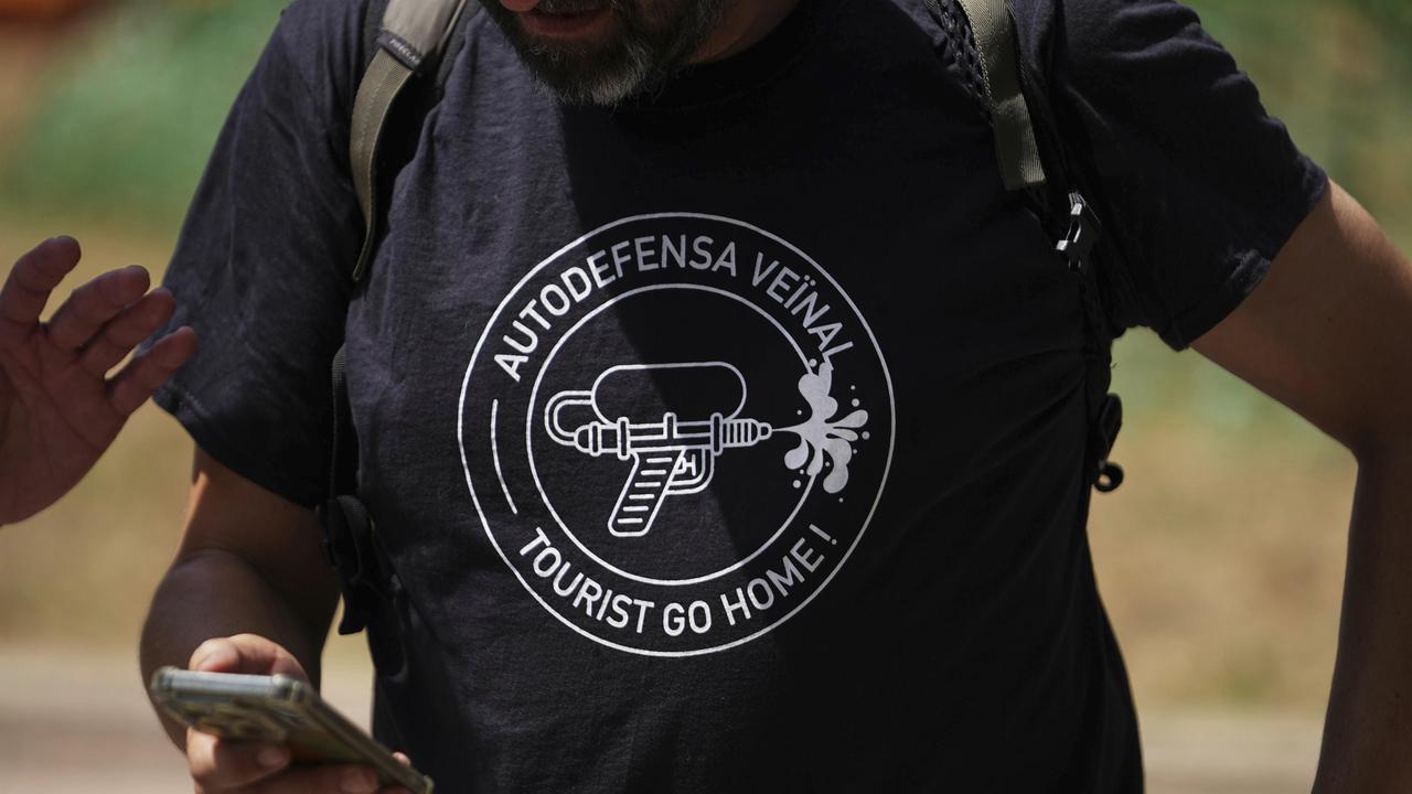 A person wears a T-shirt saying 