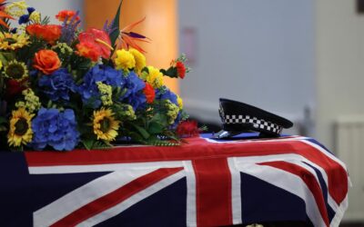 Sea of blue circles officer’s coffin as funeral begins