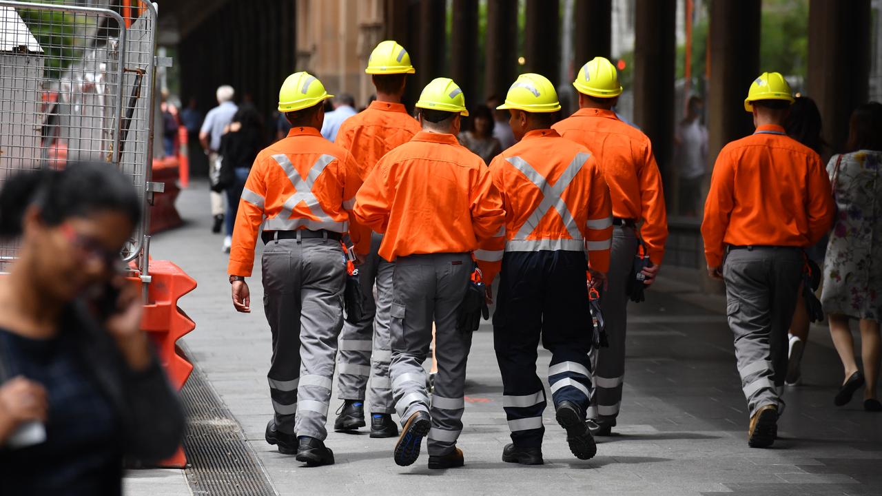 Construction site workers and office workers (file image)
