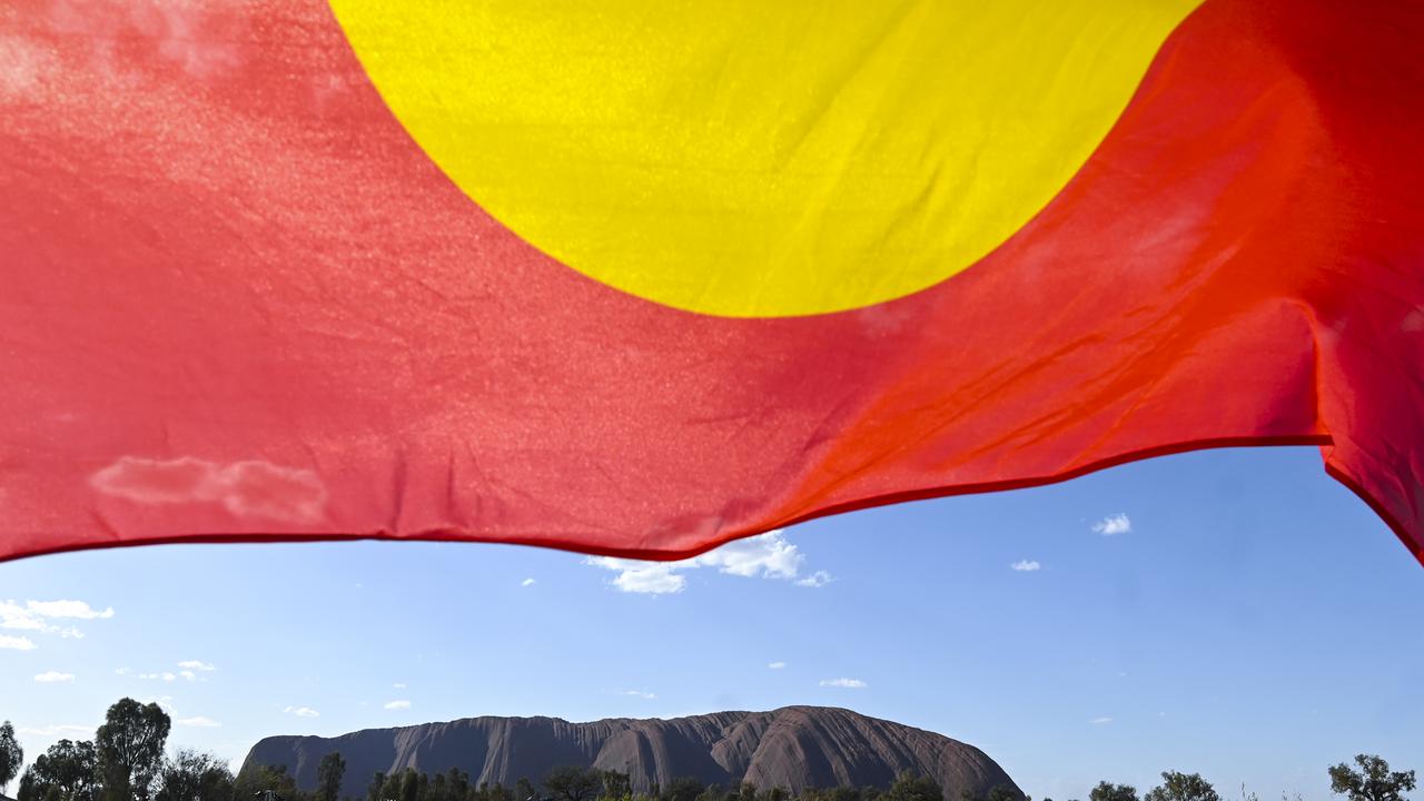 Aboriginal flag over Uluru