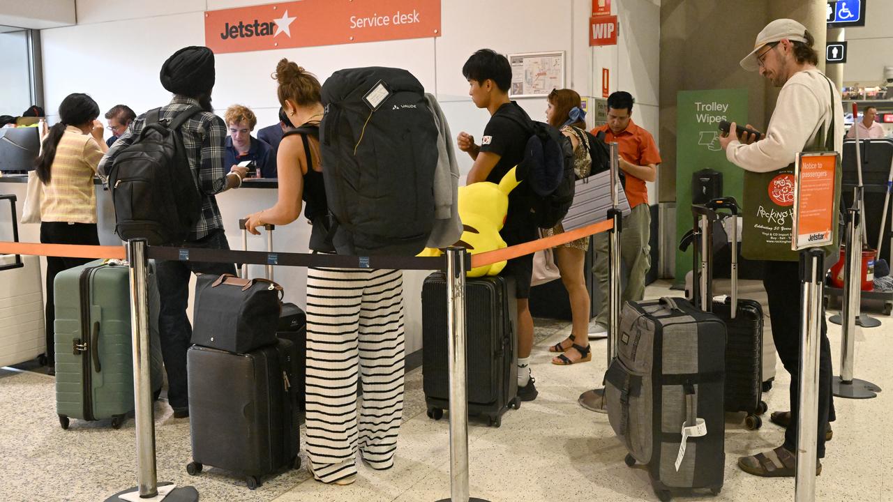 Passengers at the Jetstar service desk at Brisbane Airport