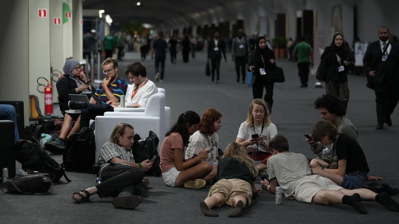 People wait for a deal at the COP30