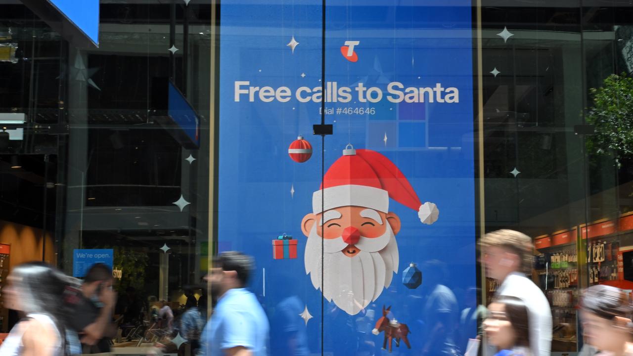 People outside a Christmas shop window