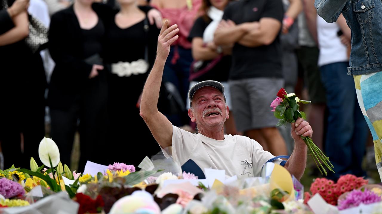Mourners place flowers at a memorial at Bondi Beach