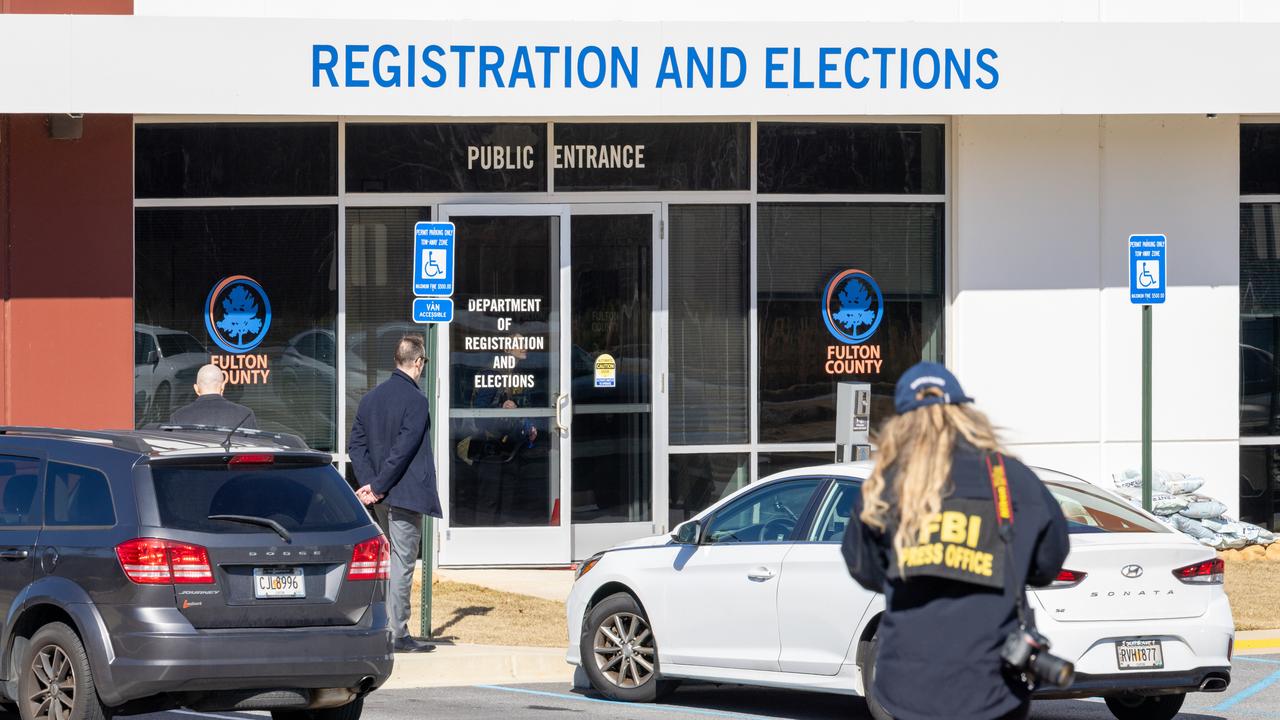 An FBI press office person approaches the Fulton County Election Hub