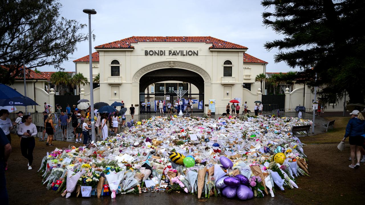 Mourners place flowers at a memorial at Bondi Beach in Sydney
