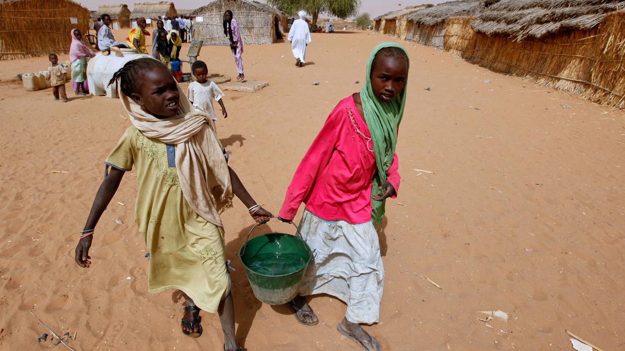 Sudanese refugee girls carry water supplies