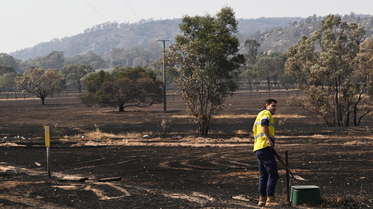 Worker checks water supply in bushfire-affected Longwood in Victoria
