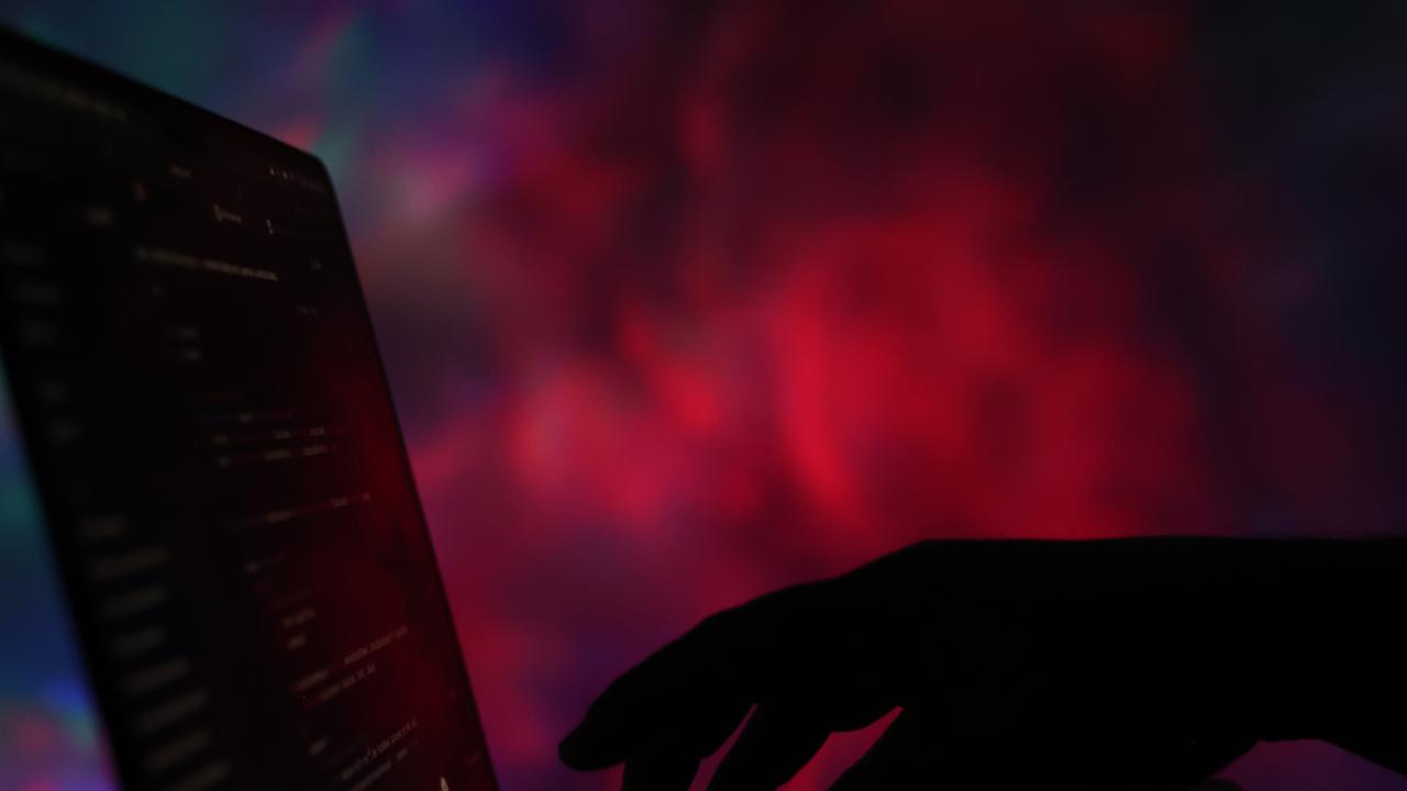 An ominous hand typing at a keyboard