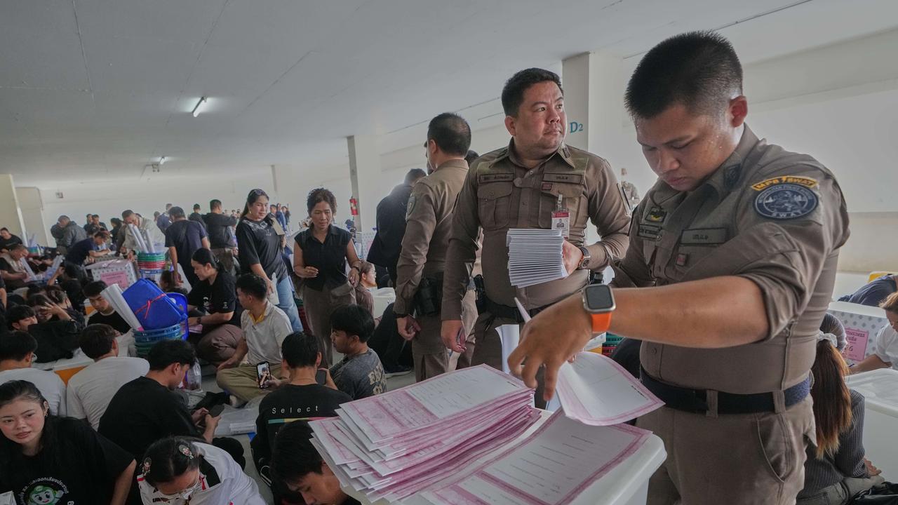 Police officers and Volunteers check ballots