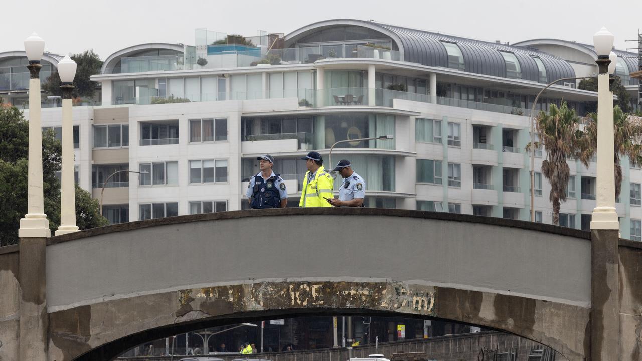 Police stand on the bridge that was used during the Bondi shooting