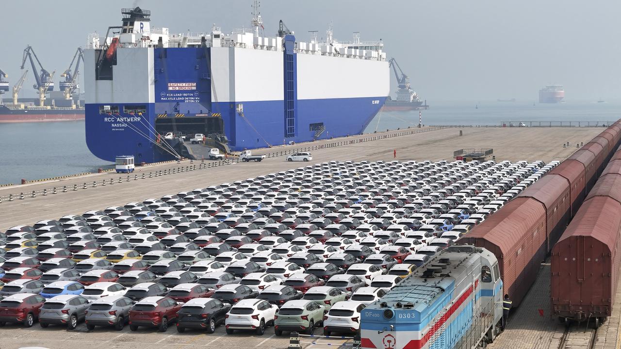 cars to be exported arrive at a dock
