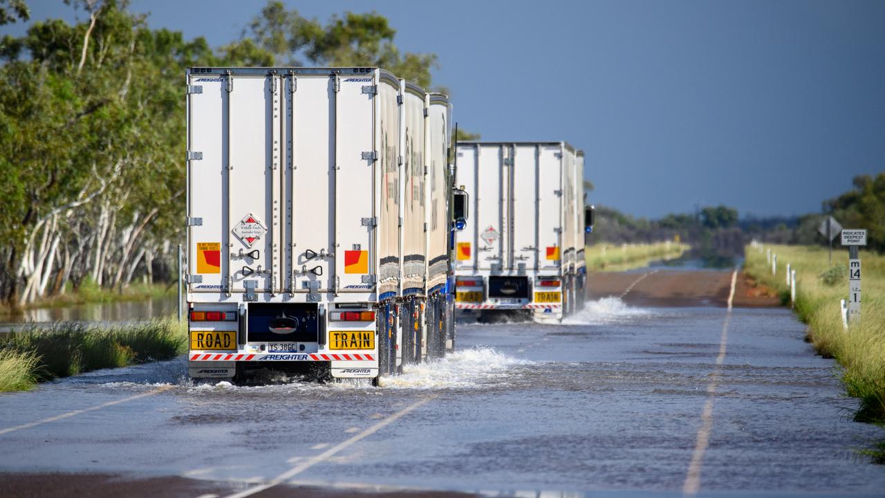 Trucks drive through floodwater on a NT highway (file image)