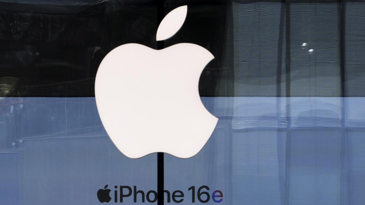 People visit an Apple Store promoting its iPhone 16