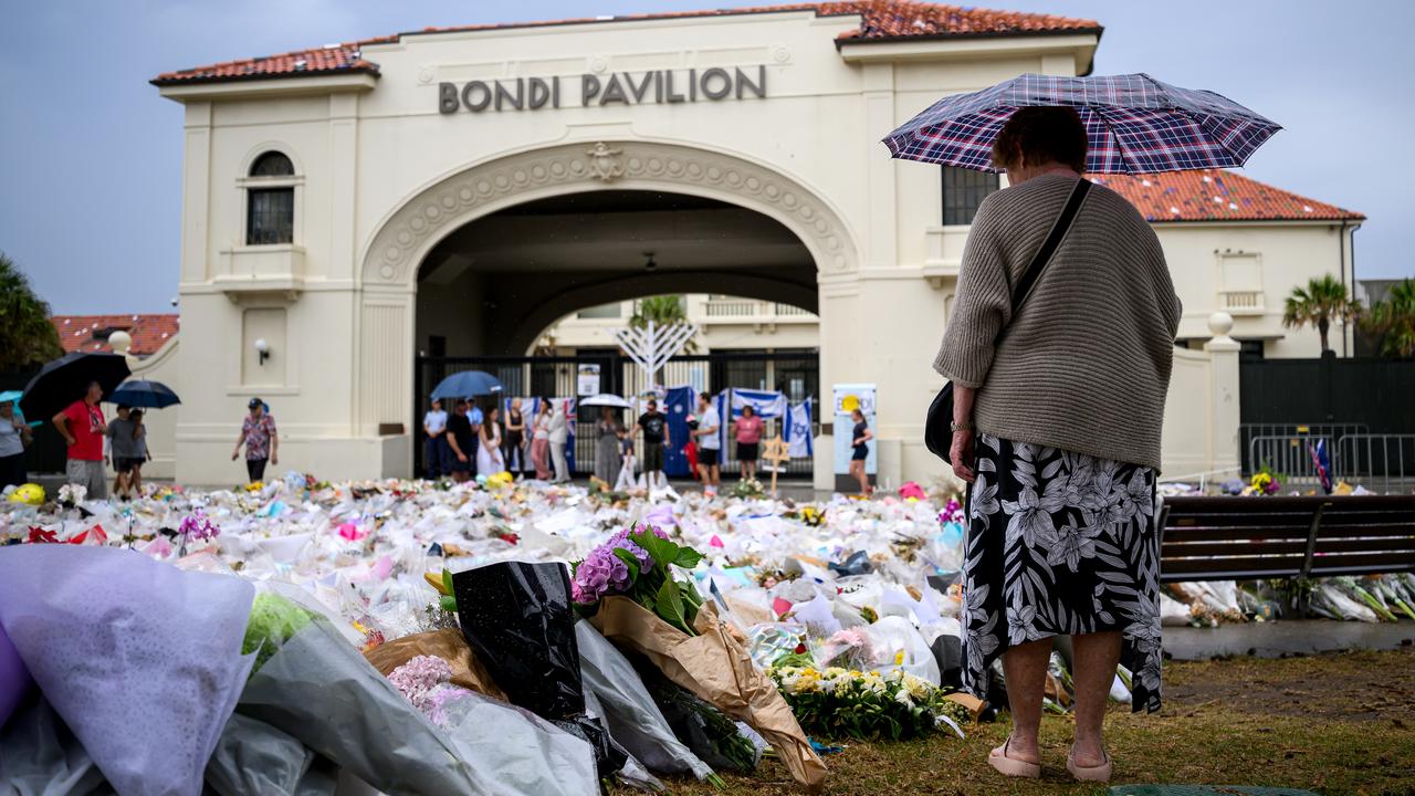Mourners place flowers at a memorial