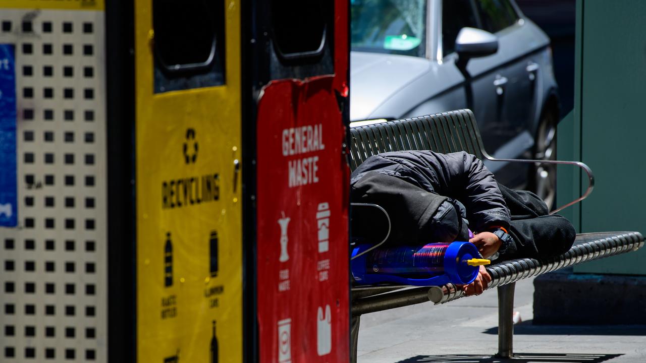 a man sleeping on a bench