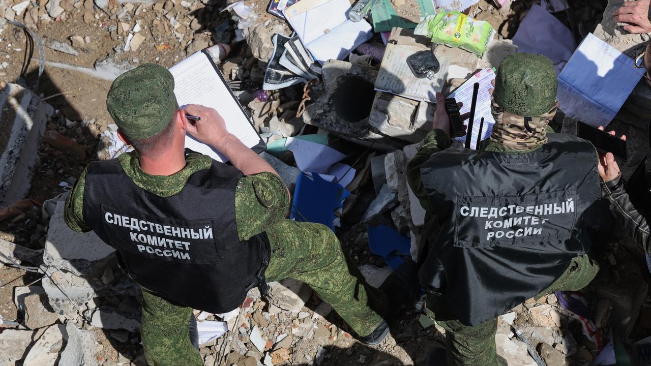Investigators comb the ruins