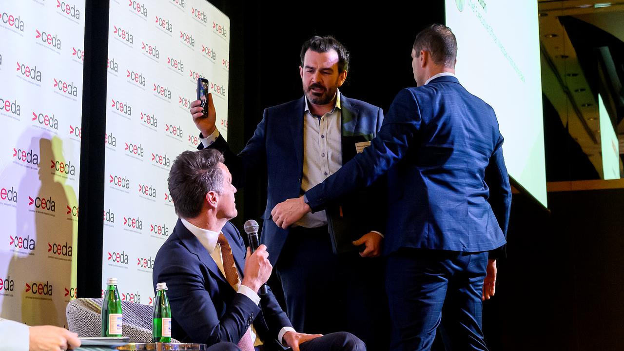 NSW Premier Chris Minns is confronted by a protester