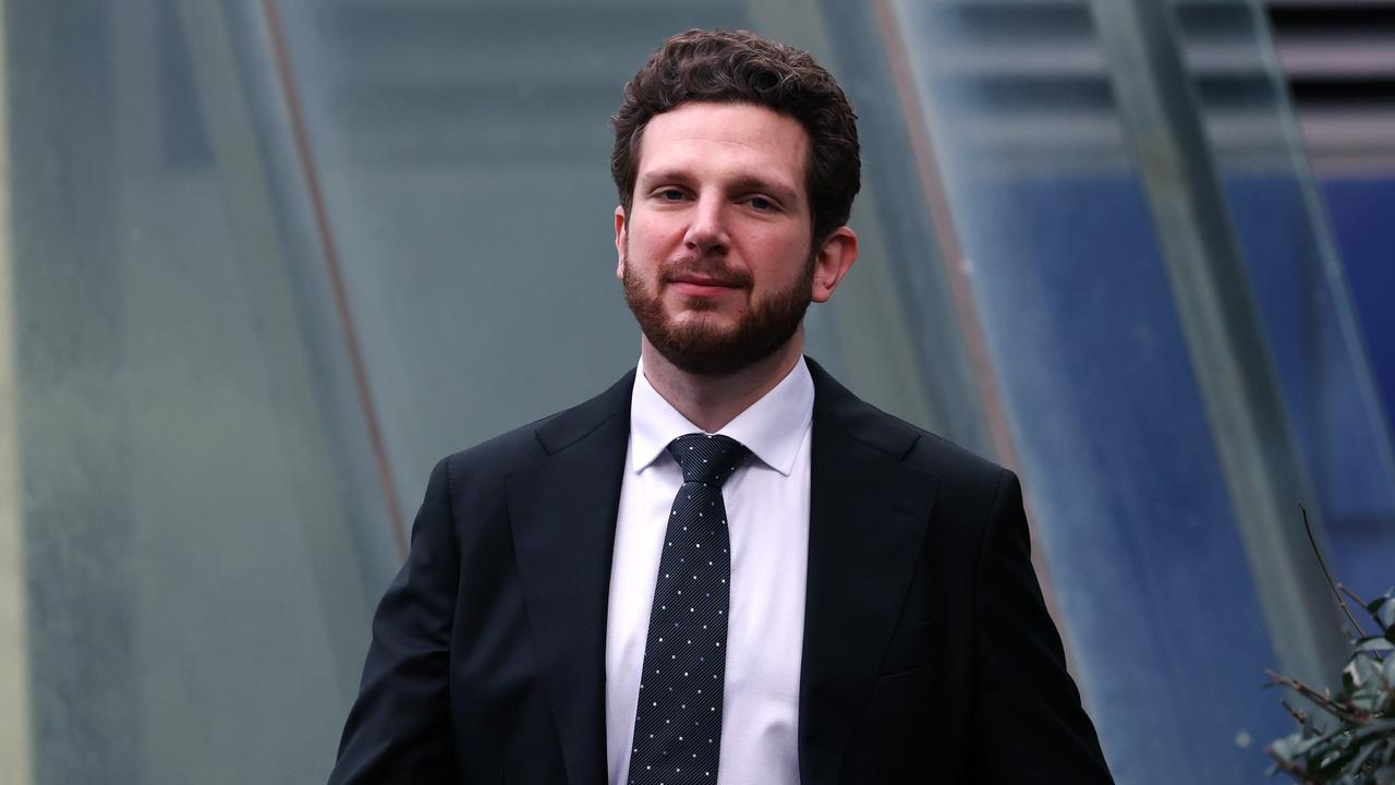 Man in a suit walks toward camera