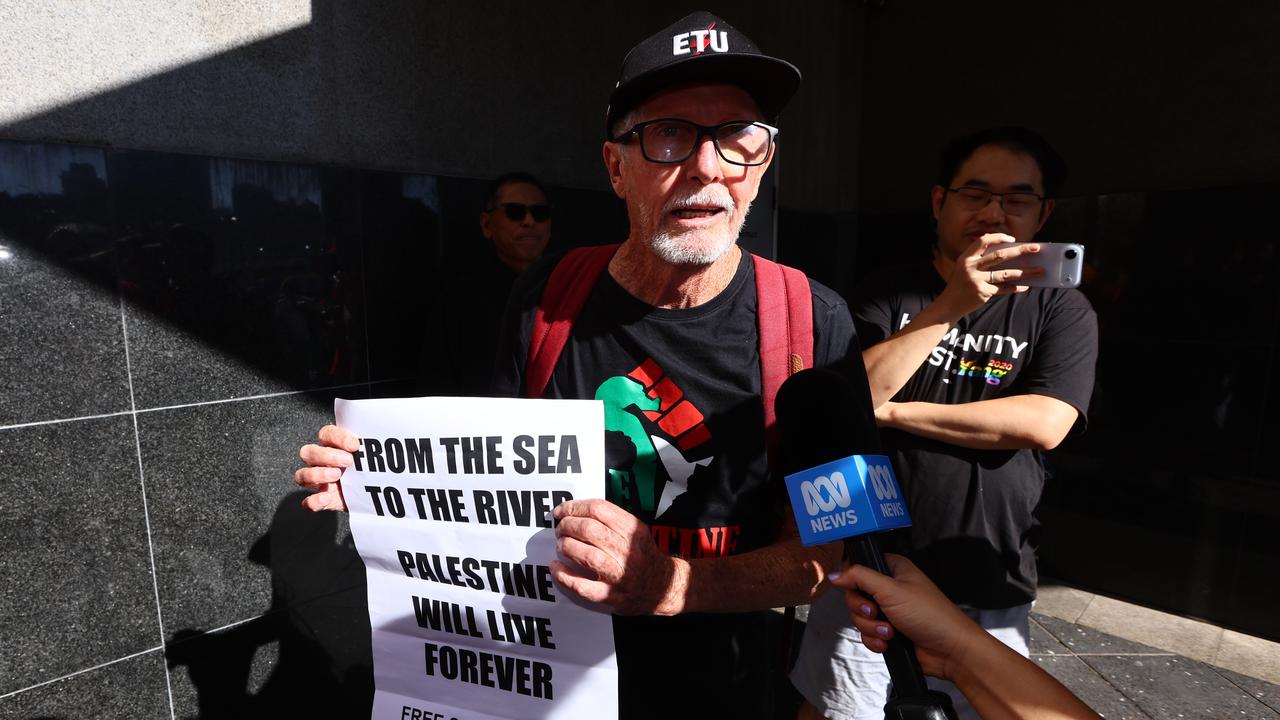 A man hold a banned slogan sign in Brisbane (file image)A