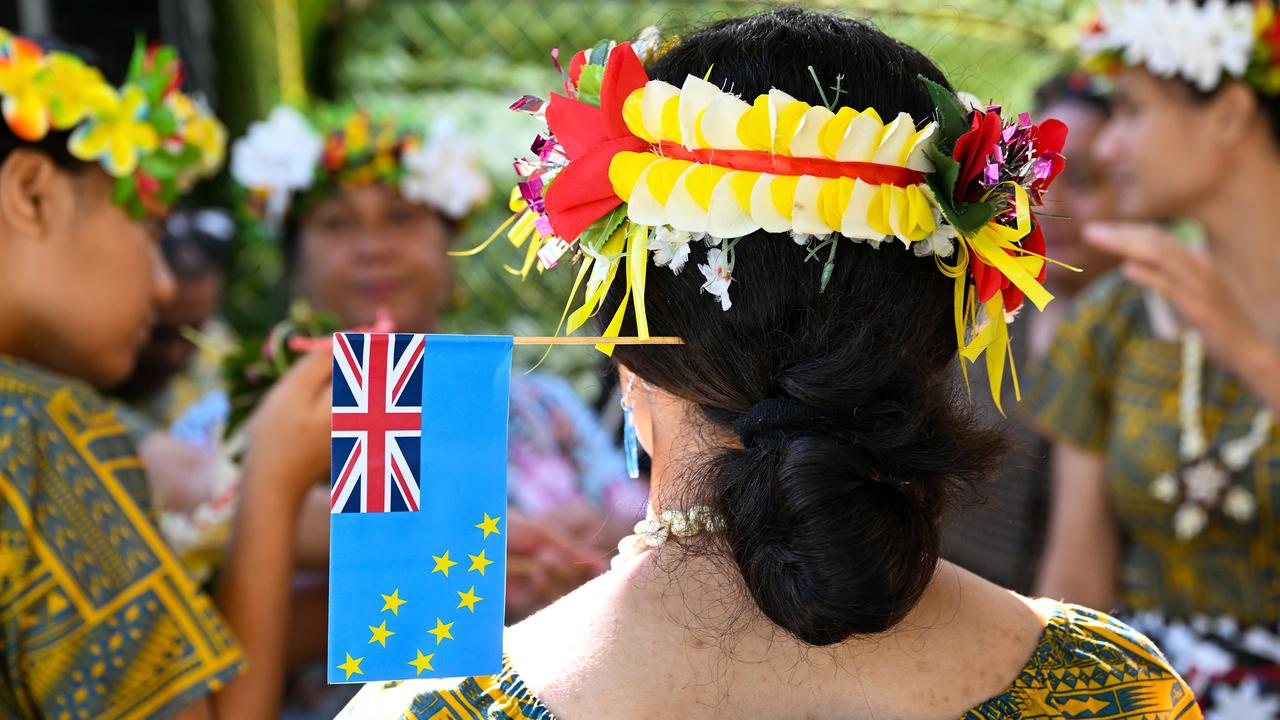A performer wears the flag of Tuvalu