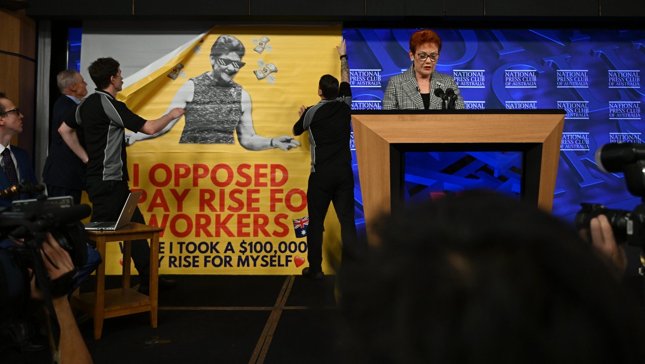 Press Club staff remove a banner seen behind Pauline Hanson